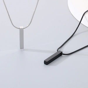 Detailed view of silver and black vertical rectangular pendant necklaces on snake chains