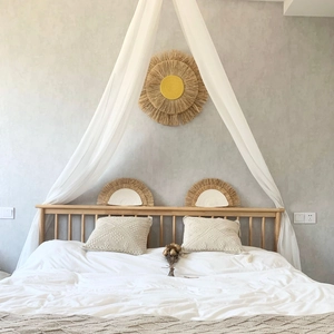 Detail of Nordic raffia wall hanging set with sun and fan shapes on textured background