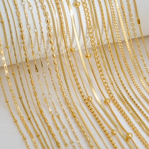 Close-up of various gold-plated snake and curb chains for multilayered necklaces