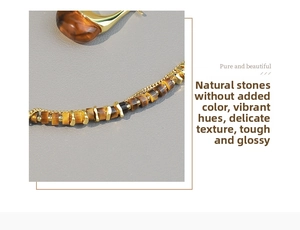 Macro shot of tiger eye stone beads and gold metal chain on vintage necklace