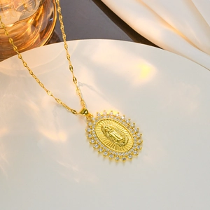 Golden necklace featuring a zircon-encrusted Virgin Mary heart pendant on white background