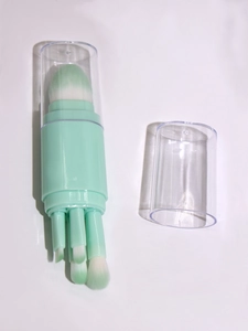Detail view of 5-in-1 retractable makeup brush set in light green with detachable brushes