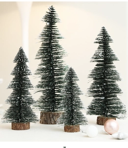 Set of four mini green Christmas trees with snow tips and rustic wooden bases