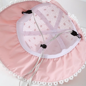 Close-up of pink sun hat with floral mesh embroidery and white lace brim detail