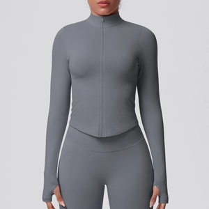 Detail of high-stretch yoga jacket sleeve featuring functional thumbholes in dark grey