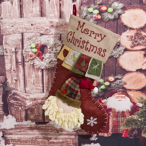 Detail of Santa Claus 3D character on brown Christmas stocking with Merry Christmas embroidery
