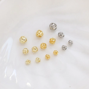 Detailed view of gold and silver hollow metal spacer beads for DIY jewelry making