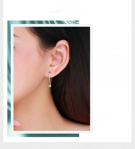 Close-up of sparkling S925 silver u-shaped earrings with pave-set pavé crystals on ear
