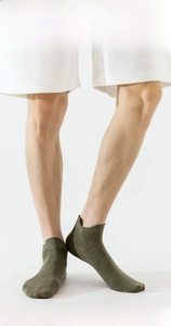 Detailed close-up of dark green combed cotton ankle socks showing breathable knit texture