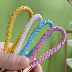 Handmade woven leather animal keychain set in four vibrant colors with gold metal hooks
