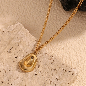 Retro 18K gold plated stainless steel cowboy hat pendant necklace on beige stone