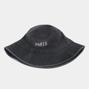 Detailed embroidery of PARIS on washed grey denim bucket hat with metal air eyelets