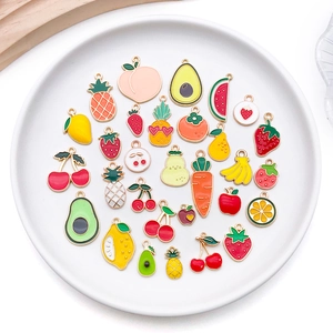 Macro shot of 27 assorted enamel fruit charms including cherry and pineapple for DIY jewelry