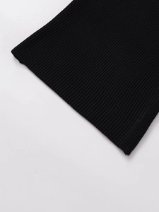 Macro shot of black ribbed knit fabric showing the detailed texture and quality material