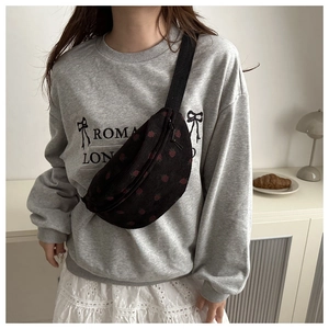 Detailed view of black corduroy crossbody bag with cute strawberry embroidery patterns