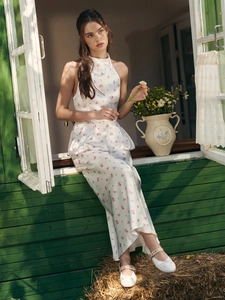 Floral print halter top and wide-leg pants set in a pastoral outdoor scene