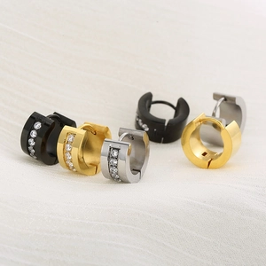 Macro detail of stainless steel huggie hoop earrings with cubic zirconia in three colors
