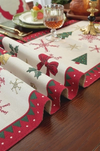 Detail of Christmas table runner with festive tree and snowflake woven embroidery