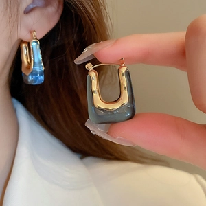 Vintage acrylic U-shaped earrings with gold metal frame and blue resin detail