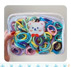 Close-up of candy-colored high-elastic hair ties in a cute bear cartoon PVC zipper bag