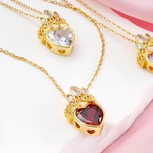 Elegant gold titanium necklace featuring heart crown pendants with ruby and zircon stones