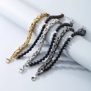 Detailed close-up of retro black onyx beads and Byzantine titanium steel men's chains