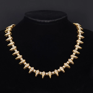 Hip hop gold plated spiked choker with sparkling rhinestones on a black velvet mannequin