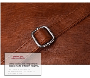 Detail of adjustable shoulder strap buckle on brown leather handbag with pebble grain