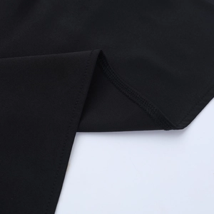 Macro view of high-quality black fabric with precise stitching and smooth textile texture