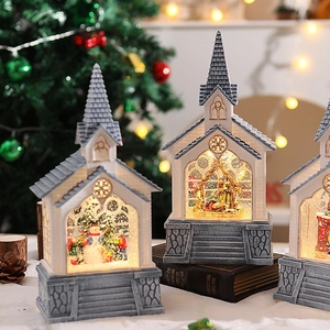 Detailed close-up of a lit Christmas church music box with snowmen and warm LED lighting
