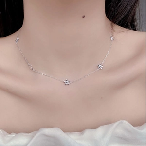 Sweet 925 sterling silver daisy flower necklace shown worn on a woman's collarbone