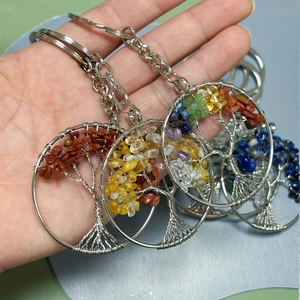 Detail of tree of life keychains with handmade wire wrapping and multi-color gemstones