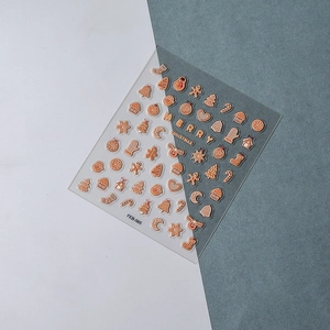 Detailed 5D embossed Christmas nail art stickers in bronze gold with festive holiday motifs