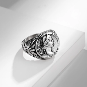 Macro shot of vintage Caesar portrait relief and laurel patterns on stainless steel ring
