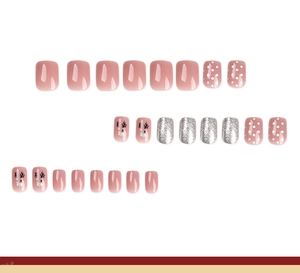 Detailed view of Christmas press-on nails with silver glitter and reindeer art patterns