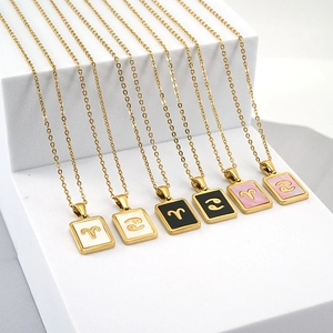 Gold 12 zodiac necklaces with 18K stainless steel and shell pendants on white steps