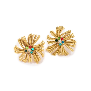 Close-up of vintage gold sea star stud earrings with colorful crystal inlay
