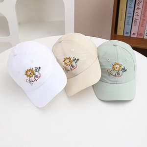 Detail of boys quick-dry baseball caps featuring cartoon lion embroidery in three colors