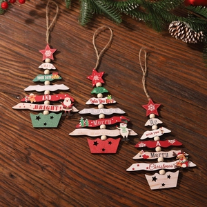 Three wooden Christmas tree ornaments with stars and Merry Christmas text on dark wood