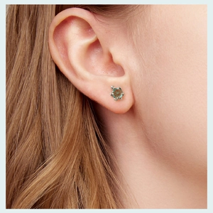 Detailed view of turtle stud earring featuring a vibrant turquoise stone in silver setting