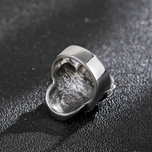 Detailed close-up of a skull ring showing the contrast between polished edge and inner texture