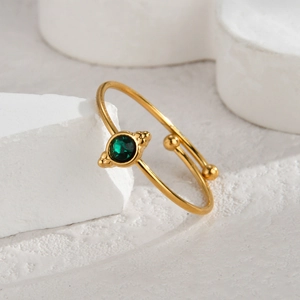 Close-up of adjustable 14K gold stainless steel bracelet with a round green gemstone