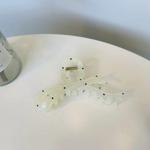 Elegant large hair claw clip with black polka dots on transparent material for women