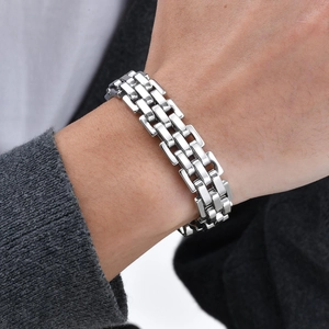 Polished silver stainless steel link bracelet for men shown on a model's wrist detail