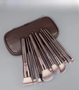 Detailed flat lay of 12 professional coffee brown makeup brushes with a PU leather zip case