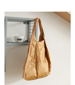 Close-up of the textured brown Tyvek tote bag with crinkled finish and fabric straps