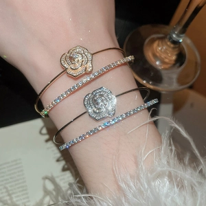 Close-up of elegant double-layer floral zircon open bracelets and diamond bracelets on wrist
