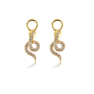 Detailed view of gold snake earrings paved with clear cubic zirconia on a white background
