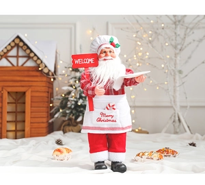 Close-up of Santa Claus chef doll holding a welcome sign in a festive holiday scenery