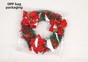 Close-up of 40cm Christmas wreath with red poinsettia flowers and gold pine cones